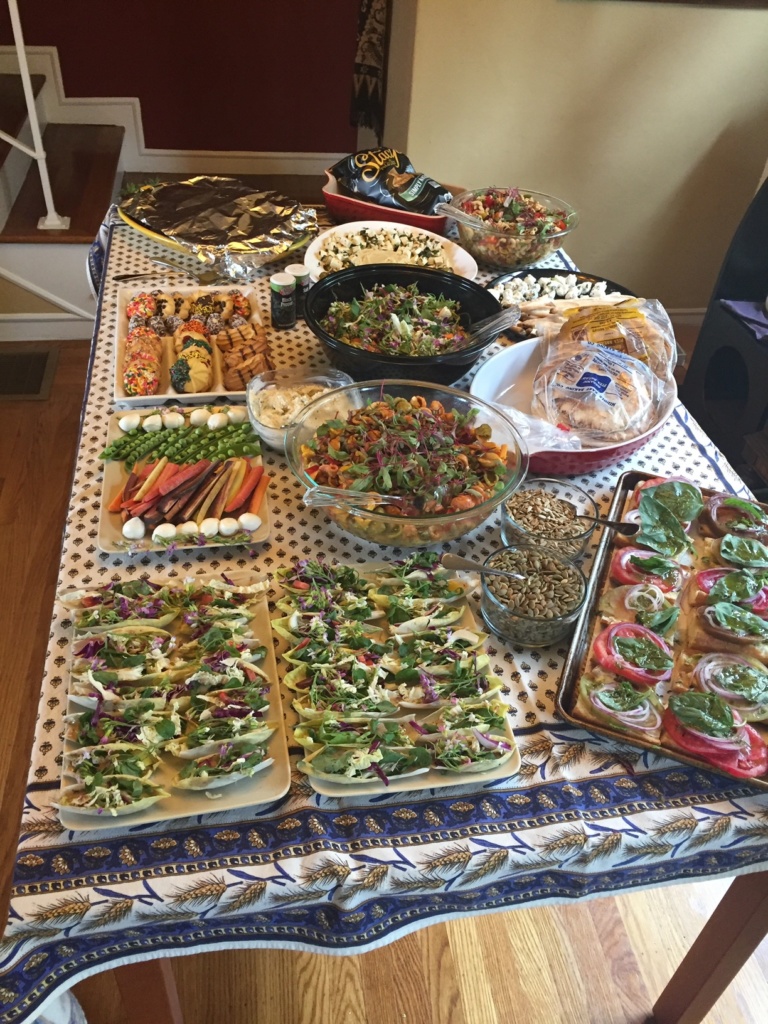 A photo of my dining table covered in foods I prepared for a party.