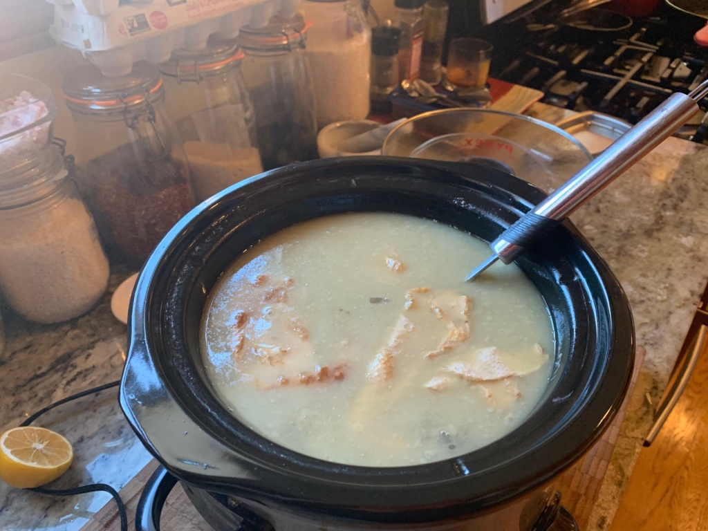 Photo of chicken cooking in water.