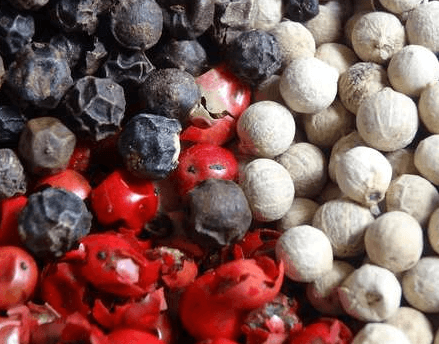 Picture of black and gray peppercorns with red too,.