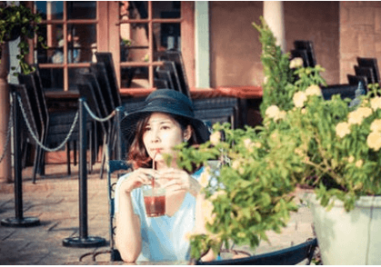 Picture of a woman sipping a drink through a straw.