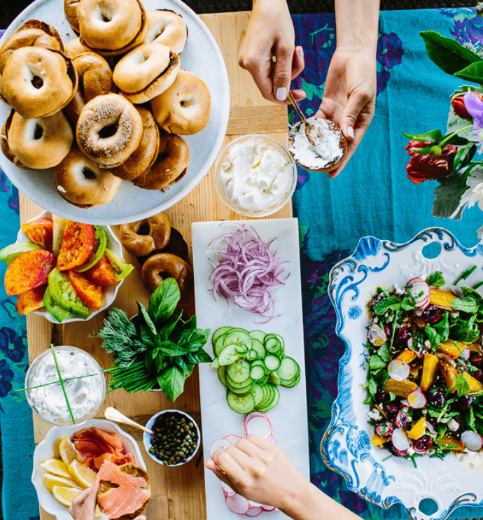 Picture of a table laden with food to fit into a bagel.