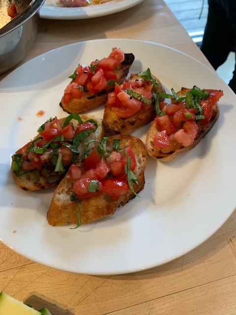 Disk of grilled bread with tomato topping.