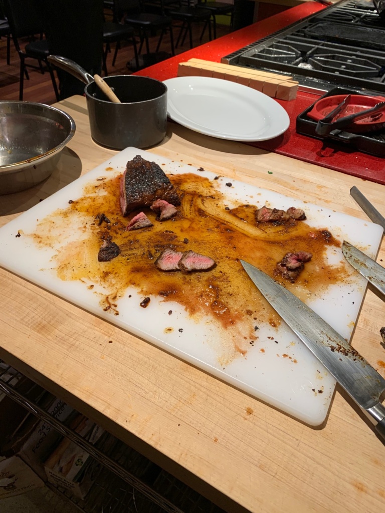 Cut tri tip on a meat cutting board.