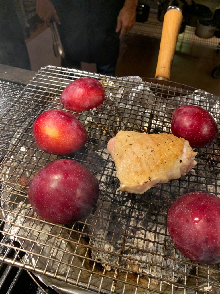 Halved plums on the grilling pan.