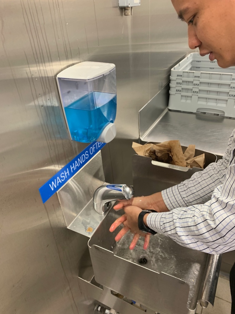 Photo of a staff person washing their hands.