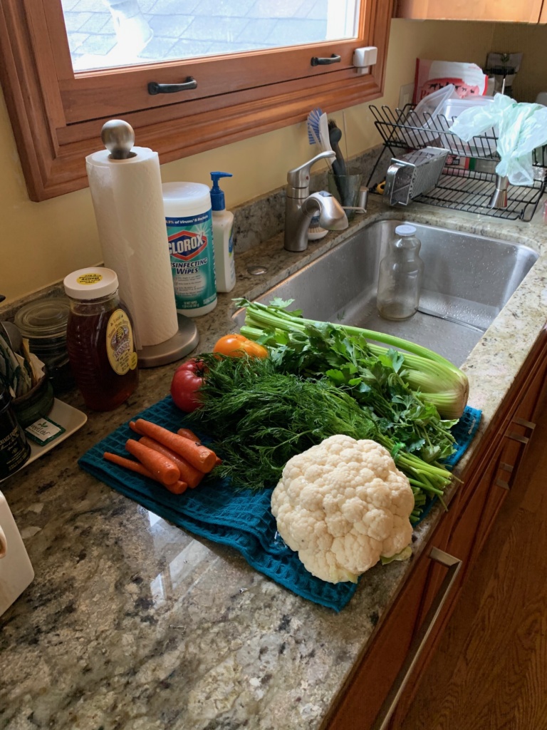 Photo of my kitchen sink with washed veggies on the side.