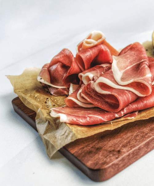 Photo of prosciutto on a cutting board.