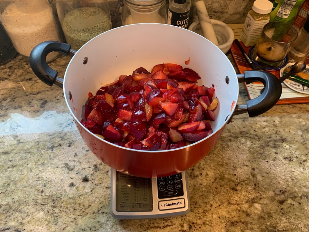 Photo of de-seeded and chopped plums measuring a little over 3 pounds.