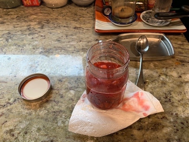 Jar of freshly poured Strawberry compote.