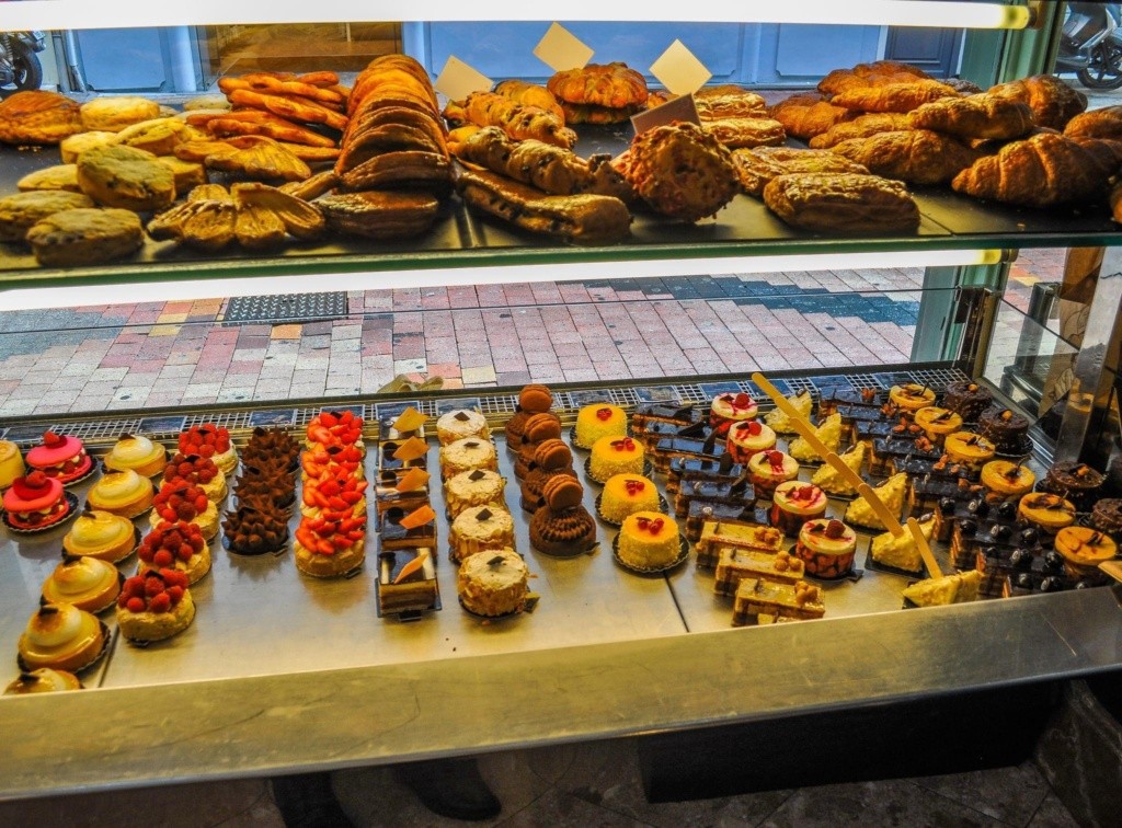 Photo of a French bakery, taken from the inside of the display window looking out onto the street.