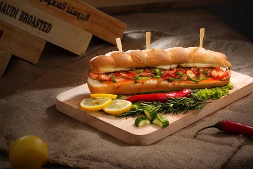 Image of a colorful sandwich on a cutting board.