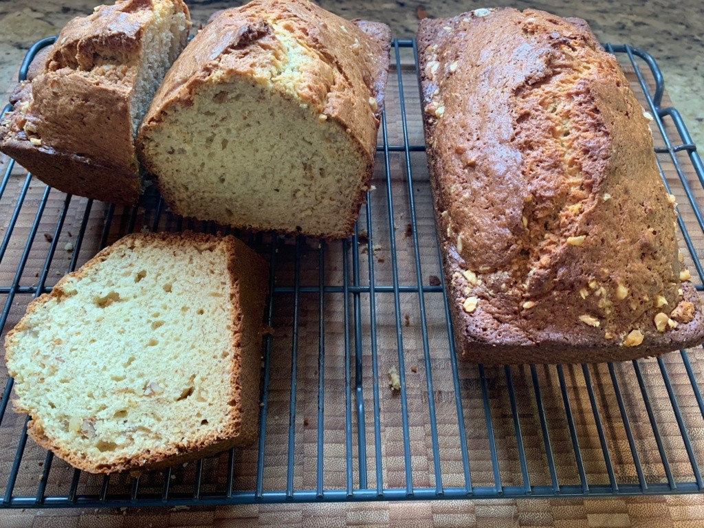 Photo of two Banana + Nut loafs, one is cut.