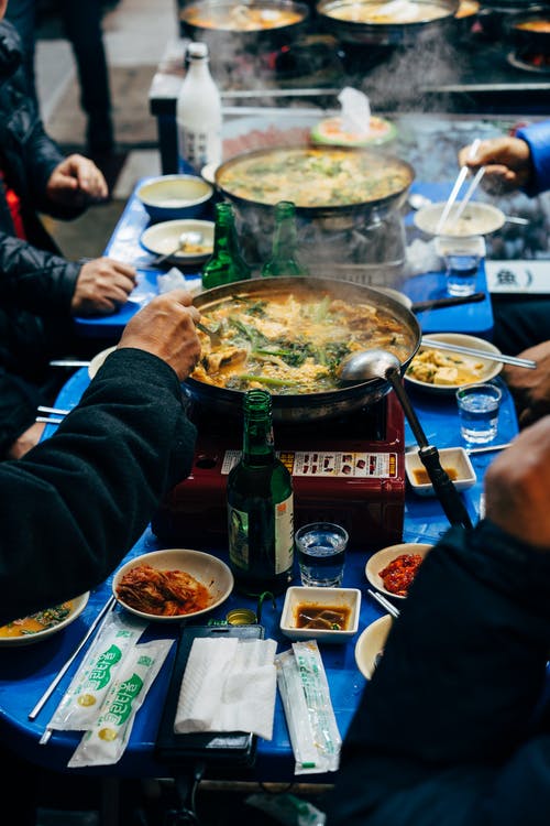 Photo of people eating Korean foods.