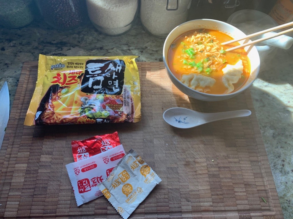 A photo of the packaging and a bowl of soup.