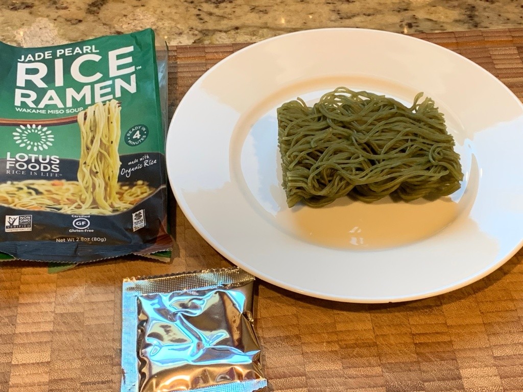 A while plate with the green noodle puck and its packaging.