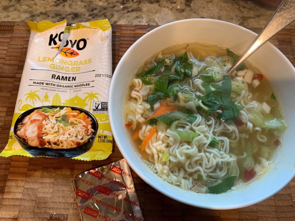 Photo of the noodle + soup package, the broth packet, and a bowl of soup with added veggies.