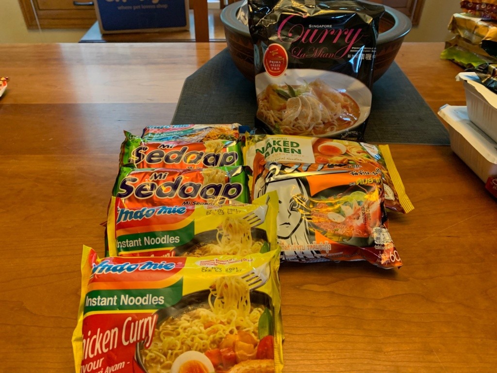 A photo of a handful of imported packages of noodles + soups.