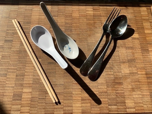 Photo of utensils used to eat noodles and soup on my bamboo cutting board.