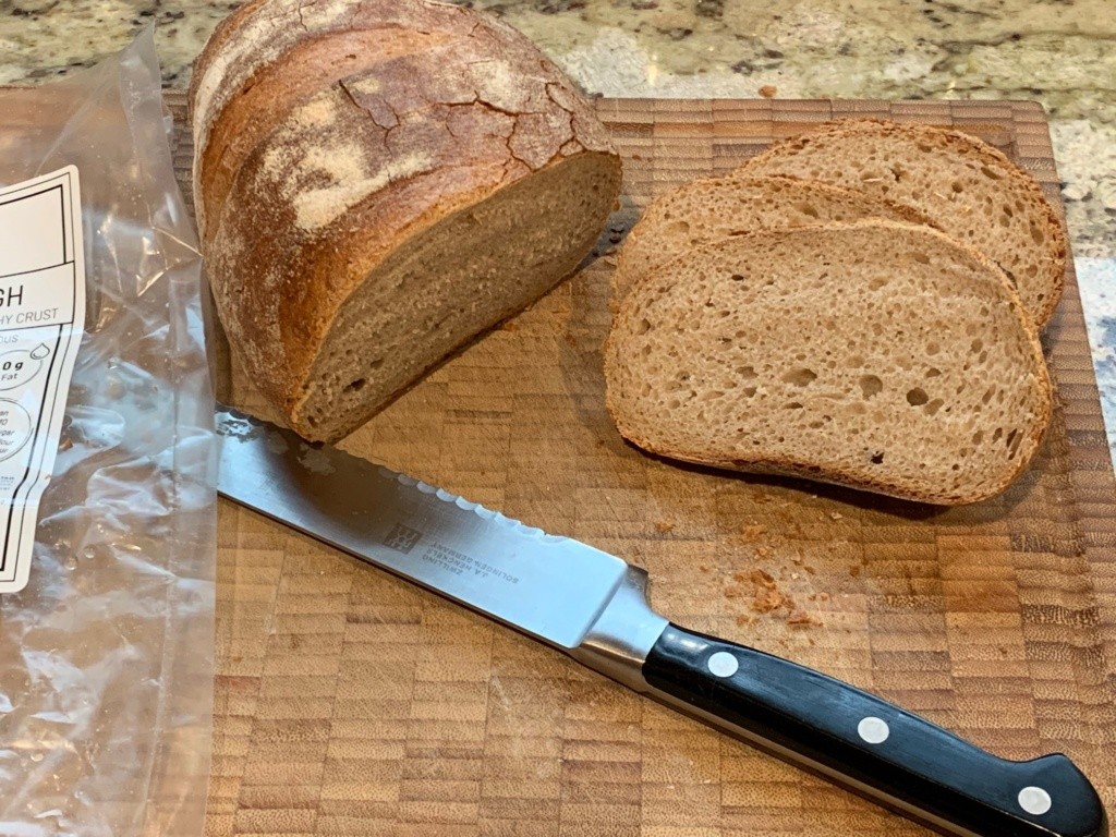 A picture of my cutting board with the loaf and slices to show again its density.