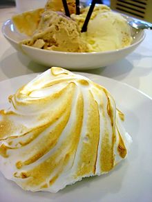 A photo of a baked Alaska with browned meringue.