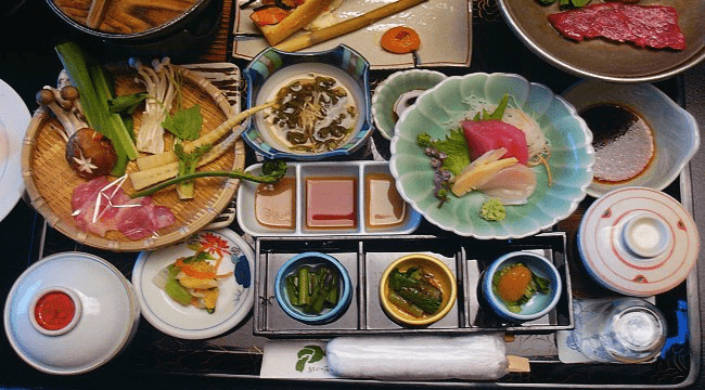 A photo of a complicated, multi dish Japanese settingl