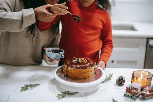 Picture of a child and adult cooking together, making a cake.