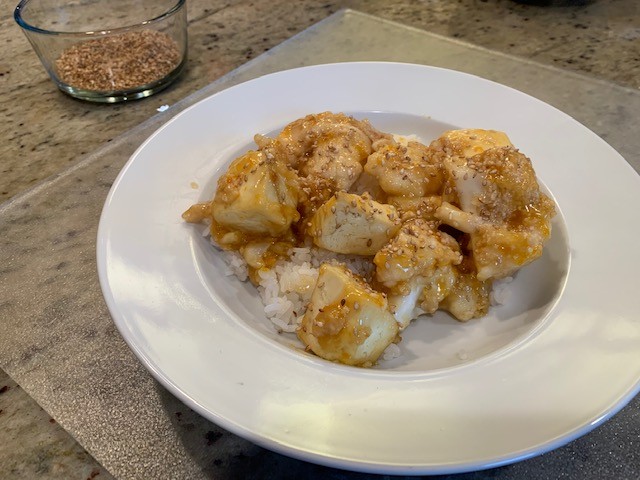 Photo of the cauliflower and tofu orange dinner over white rice.