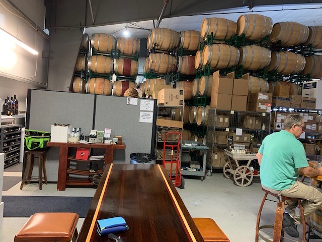 Our table and our neighbors at the oil and wine tasting storage facility with large oak barrels around us.